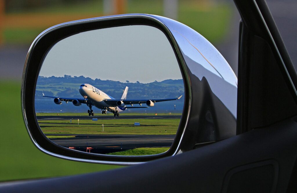 passenger-traffic-airline-aviation-air-transportation-69121-69121 A jet airplane taking off is reflected in a car's side mirror, capturing a unique aviation perspective.
